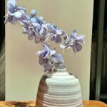 Classic ceramic vases in Uganda with artificial light blue flowers